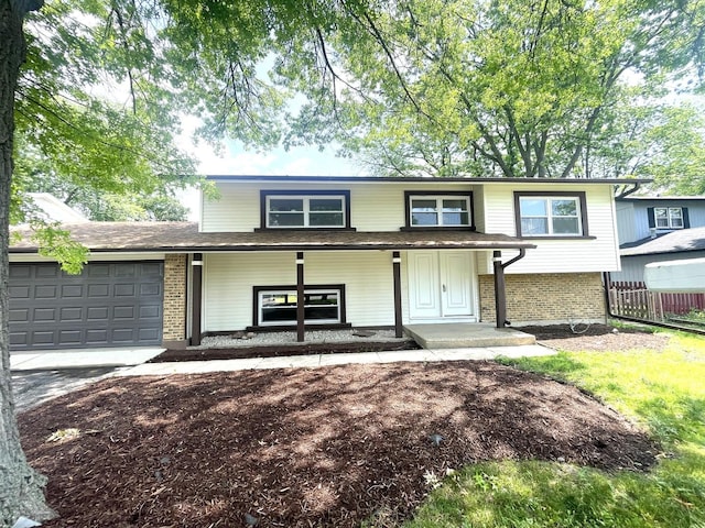 215 Brighton Rd, Elk Grove Village, IL 60007 - view of front of house featuring a porch, brick siding, an attached garage, and driveway