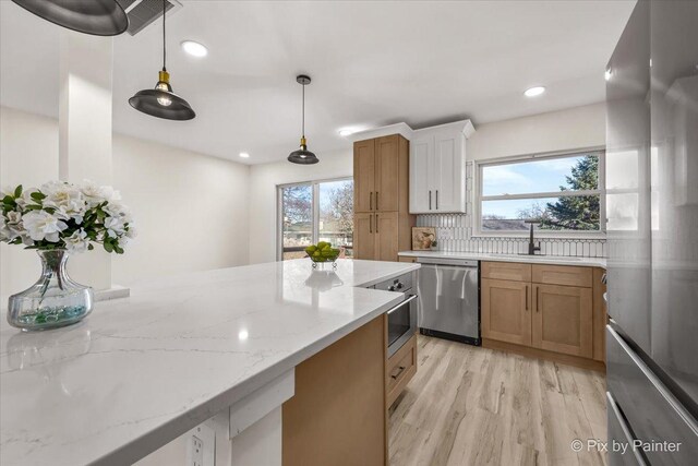 215 Brighton Rd, Elk Grove Village, IL 60007 - kitchen with stainless steel appliances, healthy amount of natural light, light wood-style flooring, light stone counters, and recessed lighting