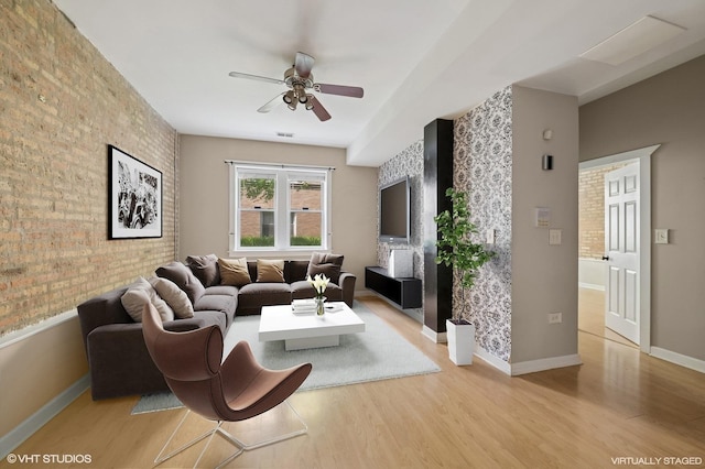 4510 N Ashland Ave Unit Gw, Chicago, IL 60640 - living area featuring ceiling fan, light wood-style floors, brick wall, and an accent wall