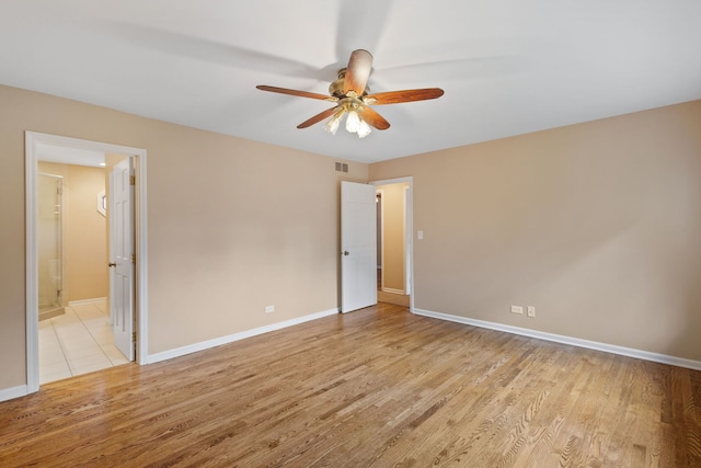 500 W Evergreen St, Wheaton, IL 60187 - unfurnished bedroom with light wood-style floors, ensuite bathroom, and ceiling fan