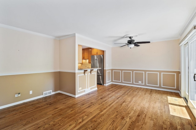 500 W Evergreen St, Wheaton, IL 60187 - empty room with a ceiling fan, wood finished floors, and crown molding