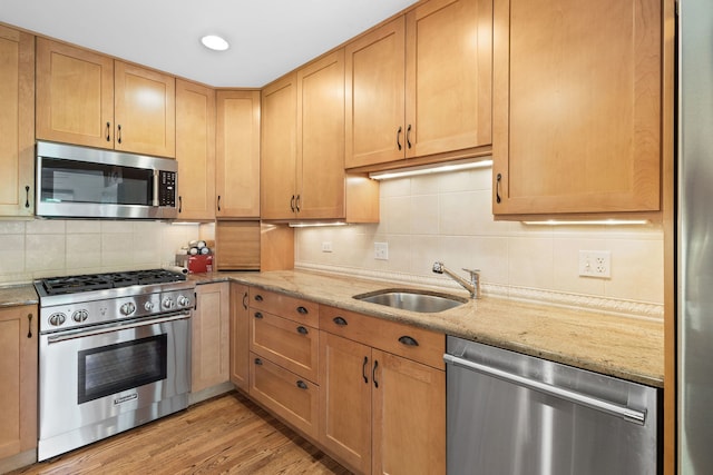 500 W Evergreen St, Wheaton, IL 60187 - kitchen featuring appliances with stainless steel finishes, backsplash, light stone counters, and recessed lighting
