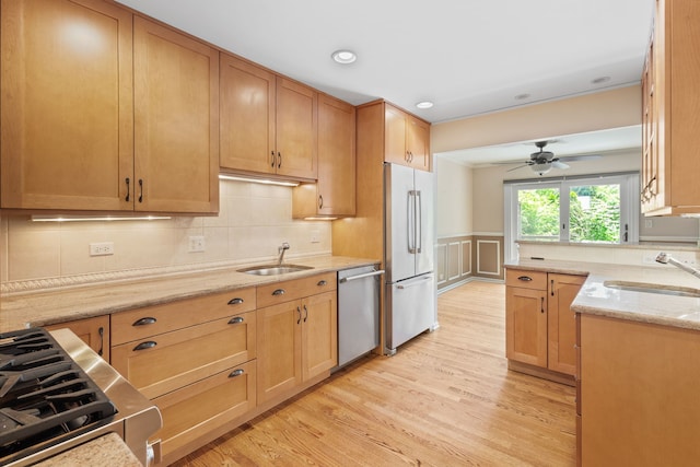 500 W Evergreen St, Wheaton, IL 60187 - kitchen with stainless steel appliances, light wood finished floors, light stone counters, decorative backsplash, and a wainscoted wall
