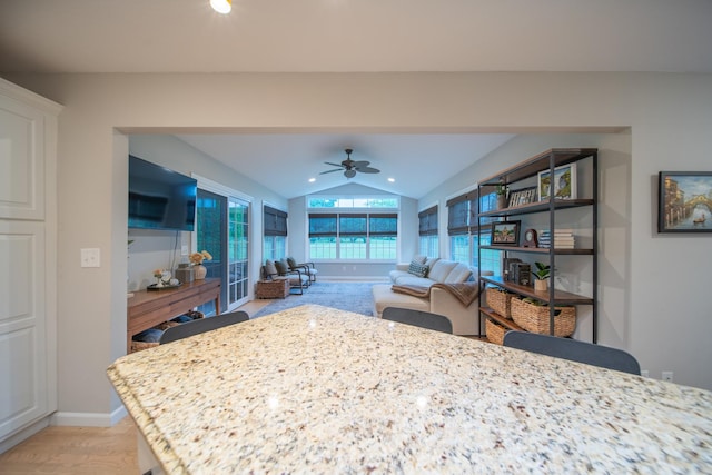 4526 Winn Rd, Sterling, IL 61081 - kitchen with vaulted ceiling, a ceiling fan, light wood finished floors, light stone countertops, and open floor plan