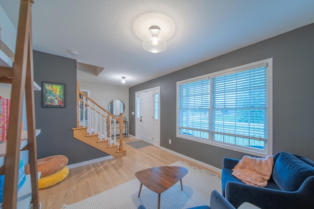 4526 Winn Rd, Sterling, IL 61081 - entrance foyer with stairs, wood finished floors, and a textured ceiling