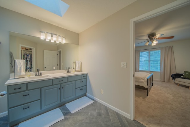 4526 Winn Rd, Sterling, IL 61081 - full bath with double vanity, a skylight, connected bathroom, and a ceiling fan