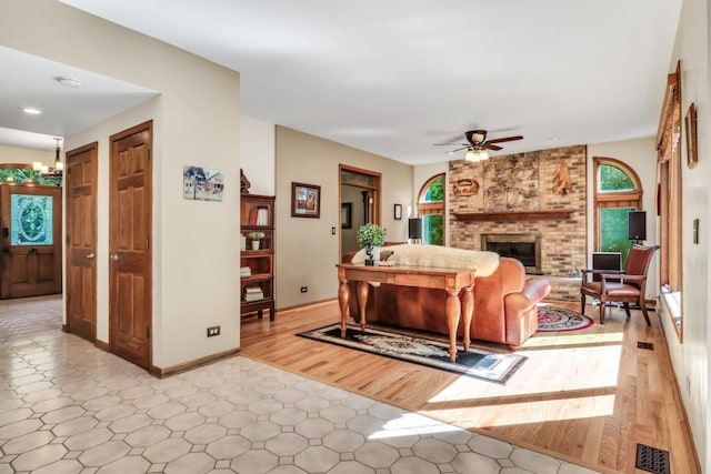 195 Hollow Way, Ingleside, IL 60041 - living room with ceiling fan, a fireplace, a chandelier, and light flooring