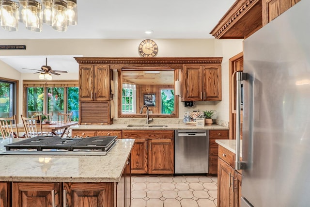 195 Hollow Way, Ingleside, IL 60041 - kitchen featuring appliances with stainless steel finishes, brown cabinets, light stone counters, and a ceiling fan