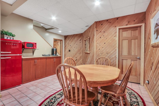 195 Hollow Way, Ingleside, IL 60041 - dining room featuring wooden walls, light tile patterned flooring, and a drop ceiling