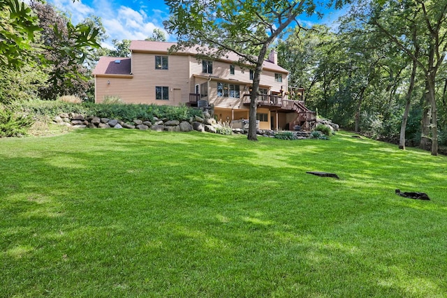 195 Hollow Way, Ingleside, IL 60041 - rear view of house featuring a wooden deck, a chimney, and a lawn