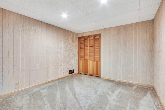195 Hollow Way, Ingleside, IL 60041 - carpeted empty room with wooden walls and a paneled ceiling