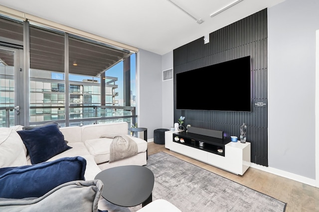 860 W Blackhawk St Unit 2106, Chicago, IL 60642 - living area with wood finished floors, a wall of windows, and an accent wall