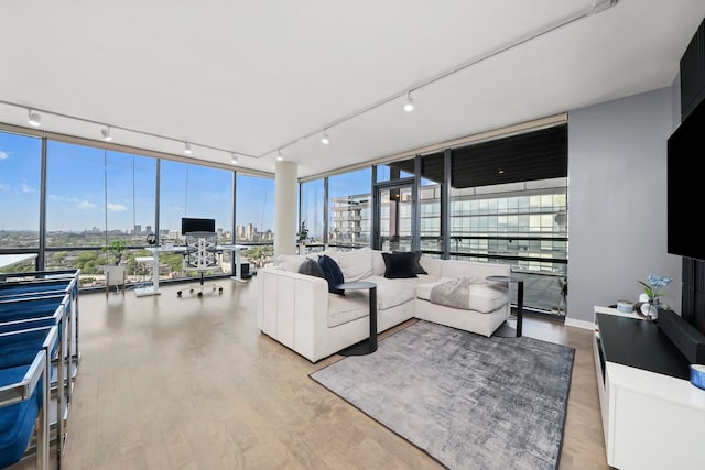 860 W Blackhawk St Unit 2106, Chicago, IL 60642 - living room with rail lighting, wood finished floors, plenty of natural light, and a wall of windows