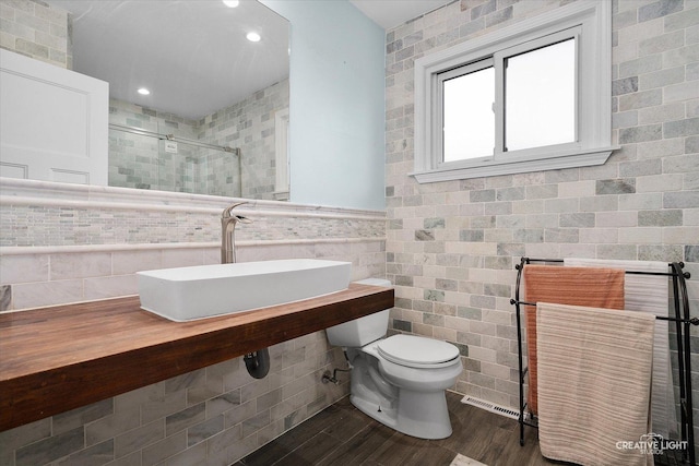 515 W Diversey Ave, Addison, IL 60101 - full bathroom with tile walls, a shower stall, wood finished floors, and recessed lighting