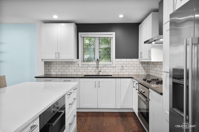 515 W Diversey Ave, Addison, IL 60101 - kitchen with appliances with stainless steel finishes, wall chimney exhaust hood, dark wood finished floors, recessed lighting, and white cabinets