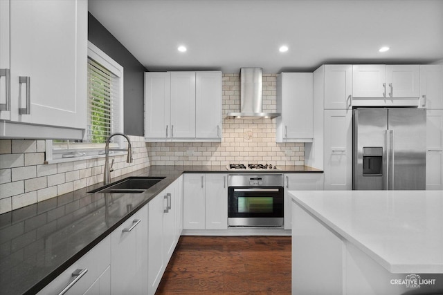 515 W Diversey Ave, Addison, IL 60101 - kitchen with appliances with stainless steel finishes, wall chimney exhaust hood, dark wood-type flooring, white cabinets, and backsplash