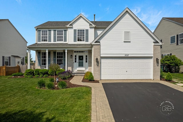 2027 Heatherstone Ct, Plainfield, IL 60586 - traditional-style house with brick siding, covered porch, asphalt driveway, and a garage