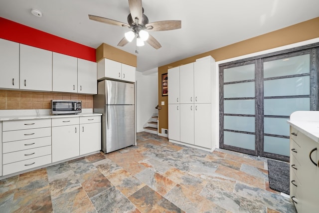 8503 W Center Ave, River Grove, IL 60171 - kitchen featuring stainless steel appliances, stone tile floors, light countertops, and backsplash