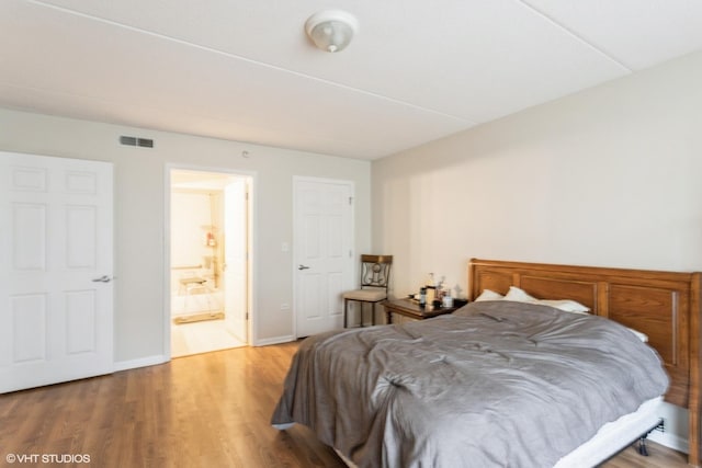 390 S Western Ave Unit 512, Des Plaines, IL 60016 - bedroom featuring wood finished floors and connected bathroom