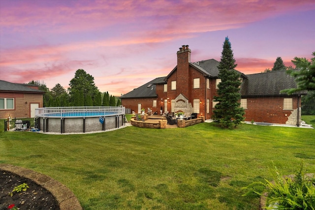 11010 W 131st St, Palos Park, IL 60464 - yard at dusk featuring a lawn and an outdoor pool