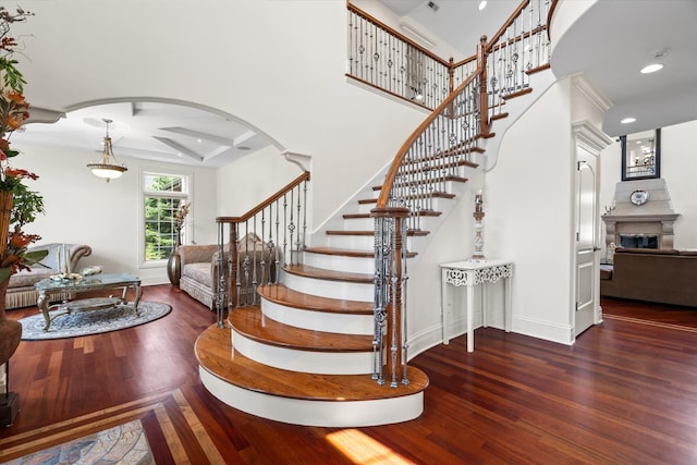 11010 W 131st St, Palos Park, IL 60464 - stairs with coffered ceiling, wood finished floors, arched walkways, recessed lighting, and a glass covered fireplace