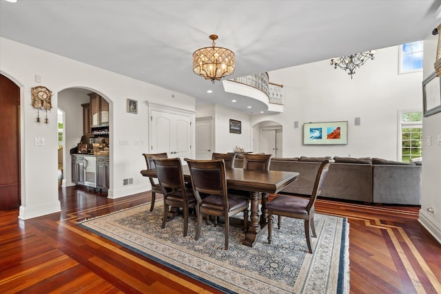 11010 W 131st St, Palos Park, IL 60464 - dining space with arched walkways, a chandelier, healthy amount of natural light, and dark wood-style floors