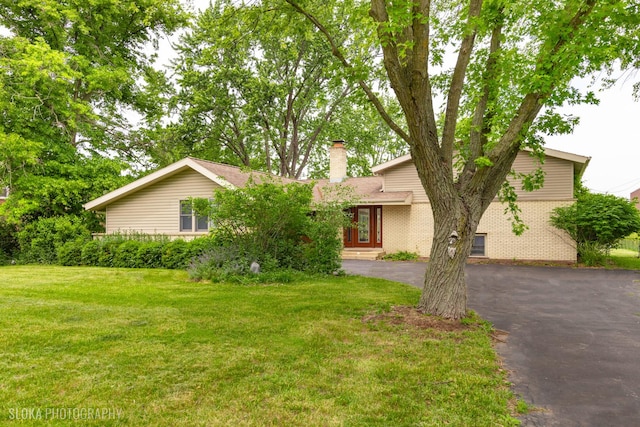 21W724 Park Ave, Lombard, IL 60148 - view of front of house with a chimney, a front lawn, brick siding, and driveway