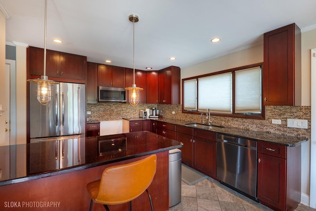 21W724 Park Ave, Lombard, IL 60148 - kitchen with stainless steel appliances, crown molding, tasteful backsplash, hanging light fixtures, and reddish brown cabinets