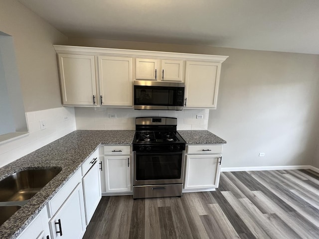 26518 W Deer Path, Channahon, IL 60410 - kitchen featuring stainless steel appliances, dark wood-style floors, dark stone countertops, and white cabinets