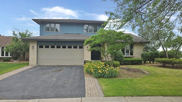8543 Carriage Ln, Tinley Park, IL 60487 - view of front of house with brick siding, asphalt driveway, a front yard, and a garage
