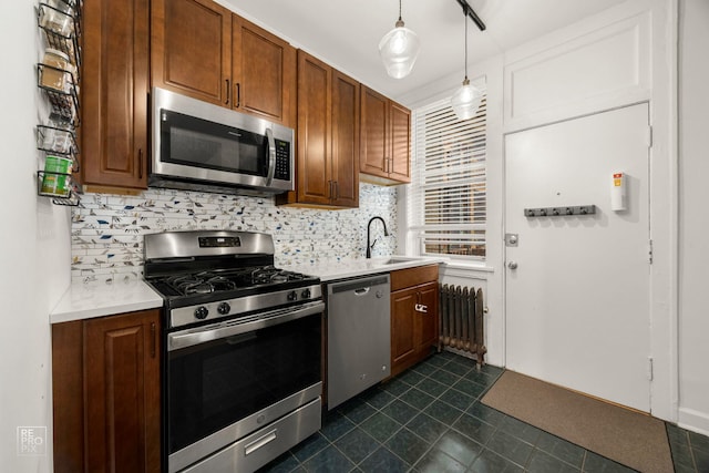 1252 W Pratt Blvd Unit 2, Chicago, IL 60626 - kitchen featuring stainless steel appliances, radiator, tasteful backsplash, and light countertops