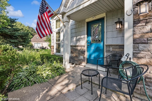 1329 Gloucester Cir, Carol Stream, IL 60188 - view of exterior entry featuring stone siding and a porch