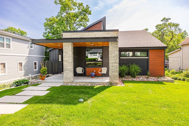 5401 Carpenter St, Downers Grove, IL 60515 - modern home with a front lawn, a shingled roof, and a patio
