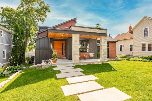 5401 Carpenter St, Downers Grove, IL 60515 - contemporary home with board and batten siding, a front lawn, covered porch, and stone siding