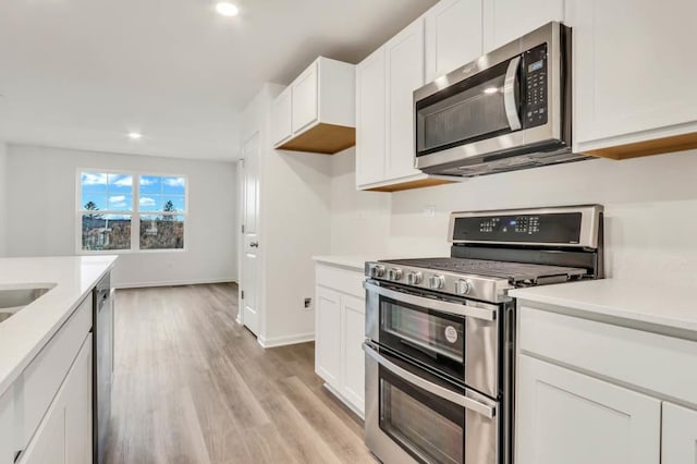 442 Lakeshore Ct, Saint Charles, IL 60174 - kitchen with stainless steel appliances, light countertops, recessed lighting, white cabinets, and light wood-type flooring
