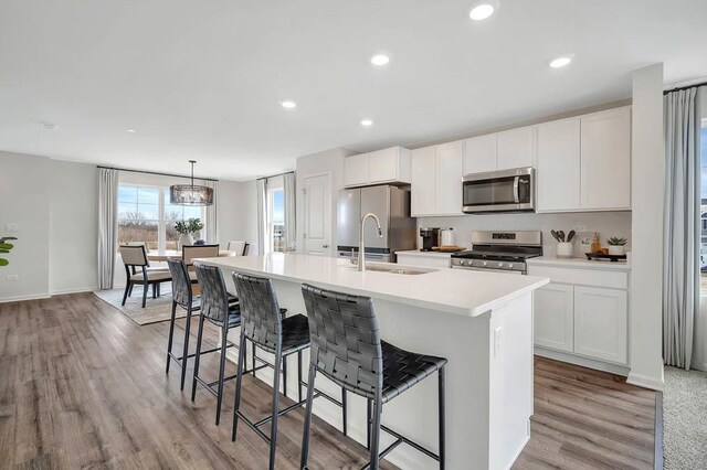 442 Lakeshore Ct, Saint Charles, IL 60174 - kitchen featuring stainless steel appliances, a kitchen island with sink, white cabinets, and recessed lighting