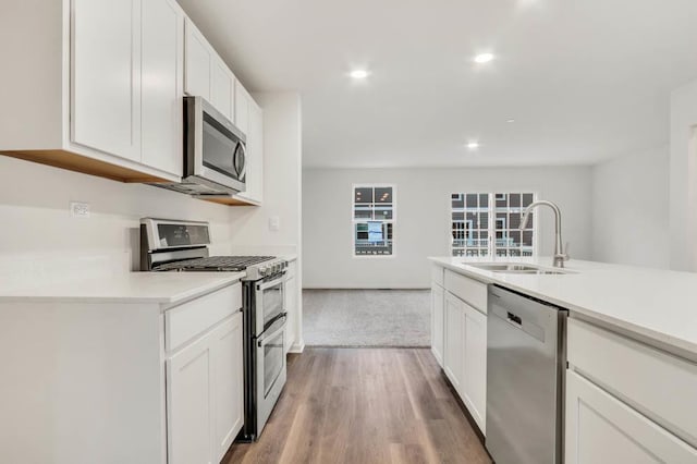 442 Lakeshore Ct, Saint Charles, IL 60174 - kitchen with stainless steel appliances, light countertops, white cabinetry, recessed lighting, and light wood-style flooring