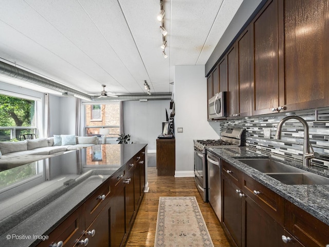 1100 W Montrose Ave Unit 207, Chicago, IL 60613 - kitchen with stainless steel appliances, dark wood-style floors, backsplash, track lighting, and open floor plan
