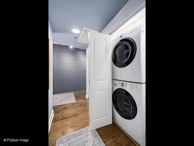 1100 W Montrose Ave Unit 207, Chicago, IL 60613 - washroom featuring estacked washer and dryer, recessed lighting, and wood finished floors