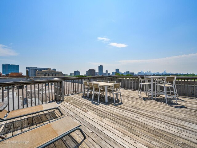 1100 W Montrose Ave Unit 207, Chicago, IL 60613 - wooden terrace featuring outdoor dining area and a view of skyline