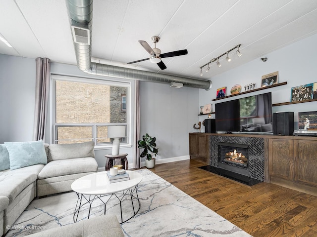 1100 W Montrose Ave Unit 207, Chicago, IL 60613 - living area featuring ceiling fan, wood finished floors, and a tiled fireplace