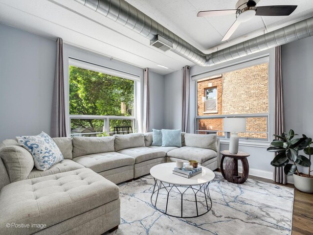 1100 W Montrose Ave Unit 207, Chicago, IL 60613 - living room featuring wood finished floors, plenty of natural light, and ceiling fan