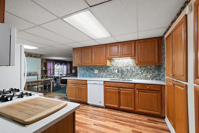 3806 168th St, Country Club Hills, IL 60478 - kitchen with white dishwasher, light countertops, brown cabinets, and a drop ceiling