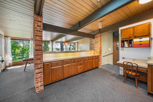 309 Holiday Dr, Lake Holiday, IL 60552 - kitchen featuring dark colored carpet, healthy amount of natural light, brown cabinets, and a wood ceiling with exposed beams
