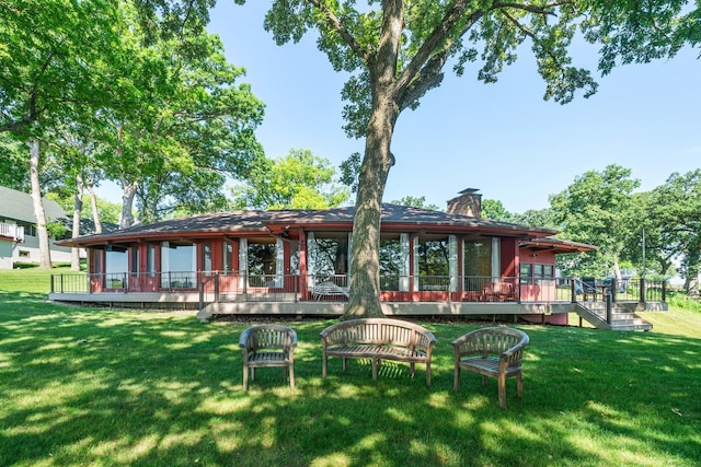 309 Holiday Dr, Lake Holiday, IL 60552 - back of house with a deck, a yard, and a chimney