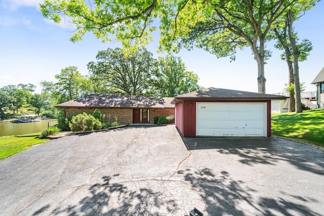 309 Holiday Dr, Lake Holiday, IL 60552 - view of front of house with driveway, a garage, a front lawn, and brick siding