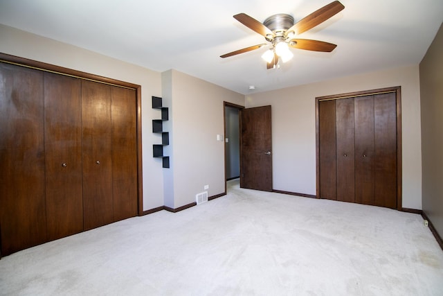 22939 E Dr, Richton Park, IL 60471 - unfurnished bedroom with light colored carpet, a ceiling fan, and multiple closets