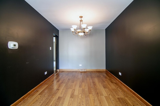 22939 E Dr, Richton Park, IL 60471 - unfurnished room with a chandelier and light wood-style floors