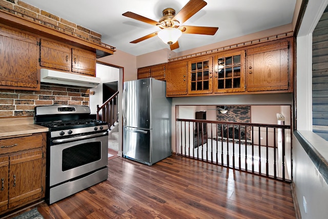 22939 E Dr, Richton Park, IL 60471 - kitchen with appliances with stainless steel finishes, under cabinet range hood, a ceiling fan, brown cabinets, and backsplash