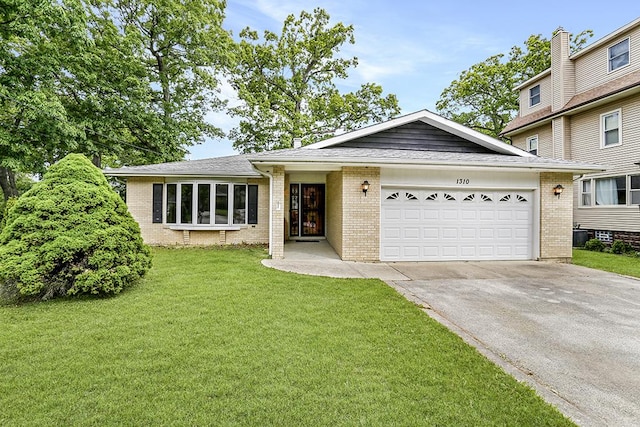 1310 Vinewood Ave, Willow Springs, IL 60480 - view of front of house with concrete driveway, brick siding, and a garage